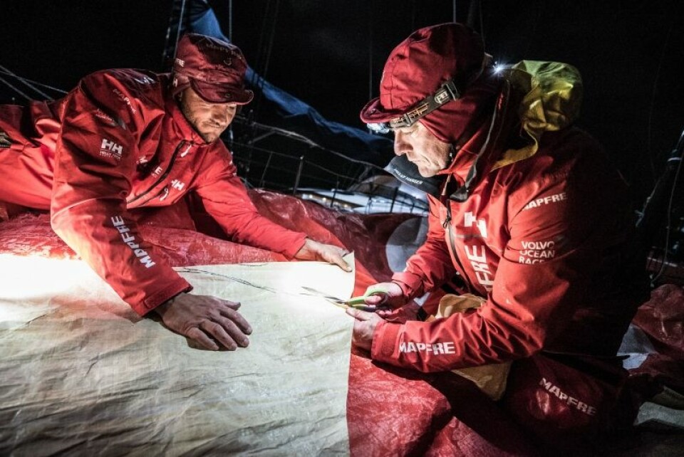 Leg 7 from Auckland to Itajai, day 12 on board MAPFRE, Santi and Blair cutting a piece of 3Di for the mainsail, 30 March, 2018.