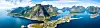 Aerial panoramic view of Reine traditional fishing village in the Lofoten archipelago in northen Norway with blue sea and mountains during sunny arctic summer