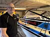 Arne Lyngholm står ved en Draco-båt under oppussing i en garasje.